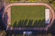 © Studio 27/Westend61 - Germany, Baden-Wurttemberg, Freiburg im Breisgau, Aerial view of running track surrounding empty football field