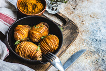Bowl Of Hasselback Potatoes With Fresh Thyme