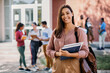 © Drazen - Portrait of happy female university student looks at camera.
