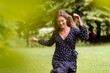 © Daniel Ingold/Westend61 - Smiling young woman in park