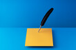 © Dreava Bogdan/Westend61 - Quill pen writing on orange paper over blue background