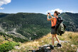 © dirk moll/Westend61 - Switzerland, Valais, woman taking picture during a hiking trip in the mountains from Belalp to Riederalp