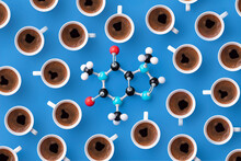 Directly Above View Of Caffeine Chemical Formula With Coffee Cups Over Blue Background