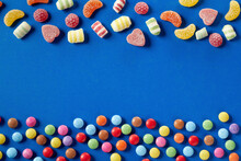 Colorful Candies On Bue Background, Copy Space