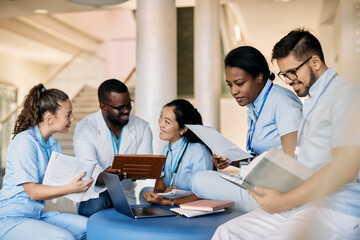 Wall Mural - Multi-ethic group of medical students study in hallway at university.