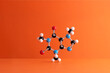 © Dreava Bogdan/Westend61 - Caffeine formula's molecular structure over orange background