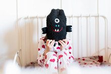 Little Girl Sitting In Bed Hiding Face Behind Her Soft Toy