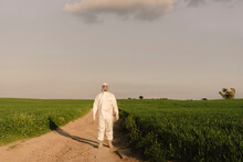 Man Wearing Protective Suit And Mask In The Countryside