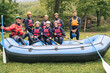 © Francesco Buttitta/Westend61 - Instructor and group of friends at a rafting class posing in boat