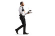 © Ljupco Smokovski - Full length profile shot of a waiter carrying a red wine decanter on a silver tray and walking