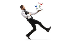 Full Length Profile Shot Of A Waiter Falling With A Tray Of Cocktails