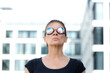 © FL/Westend61 - Mature woman wearing welder's goggles in front of an office building