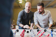 © Francesco         Morandini/Westend61 - Colleagues playing foosball in office