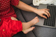 © ¬© Flavia Morlachetti/Westend61 - Mother remote working with laptop on sofa while holding her sleepy baby boy