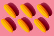 © gemma ferrando & jeremie roman/Westend61 - Studio shot of six plastic corn cobs against pink background