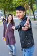 © Gemma Ferrando/Westend61 - Happy couple inviting someone to join them for a walk, Barcelona, Spain