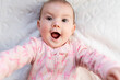 © gemma ferrando & jeremie roman/Westend61 - Portrait of baby girl with pink heart-shaped candy on nose