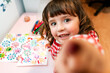 © gemma ferrando & jeremie roman/Westend61 - Little girl drawing  ugly viruses with color markers at home