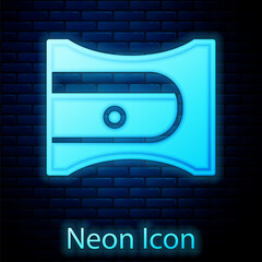 Poster - Glowing neon Pencil sharpener icon isolated on brick wall background. Vector