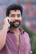 © NOVELLIMAGE/Westend61 - Smiling man talking on mobile phone in city