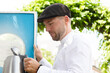 © Westend61 - Man taking pitcher from barter while standing outdoors