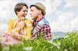 © Westend61 - Couple having a picnic on a meadow in the mountains, Achenkirch, Austria
