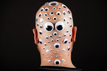 Bald Man With Head Covered In Googly Eyes