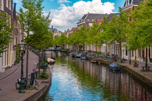 Netherlands, South Holland, Leiden, Boats And Bicycles Along City Canal