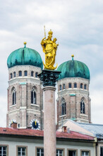 Germany, Bavaria, Munich, Mariensaule Statue With Towers OfÔøΩFrauenkircheÔøΩin Background