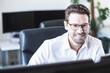 © Uwe Umst√§tter/Westend61 - Smiling businessman working at office
