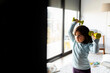© VALENTINA BARRETO PHOTOGRAPHY/Westend61 - Portrait of little girl exercising with dumb bells at home