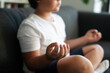 © VALENTINA BARRETO PHOTOGRAPHY/Westend61 - Boy sitting on couch meditating