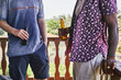 © victor espadas/Westend61 - Midsection of male friends holding beer bottles while standing in balcony