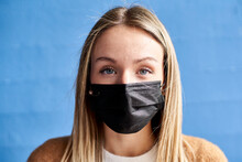 Young Woman With Protective Face Mask Against Wall