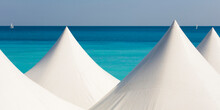 White Beach Tents Against Blue Coastal Water OfÔøΩMediterraneanÔøΩSea
