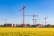 © Werner Dieterich/Westend61 - Germany, Baden-Wurttemberg, Holzgerlingen, Yellow grassy field with construction site in background