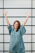 © Xavier Lorenzo/Westend61 - Euphoric woman in front of a wall