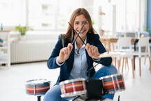 Young Businesswoman Playing Percussion