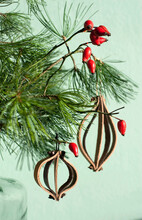 Leather Christmas Ornaments On Pine Twig With Red Rosehips