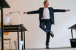 © Gustafsson/Westend61 - Senior businessman doing a yoga exercise in office