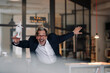 © Gustafsson/Westend61 - Excited senior businessman with wind turbine model in office