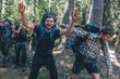 © Westend61 - Young people backpacking in nature, laughing and waving at camera