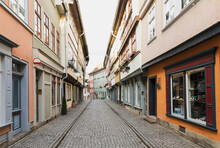 Diminishing Perspective Of Empty Cobble Street Amidst Residential Buildings In Erfurt, Germany