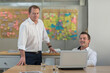 © Andreas Pacek/Westend61 - Portrait of two confident businessmen with laptop in office