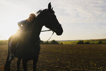 Affectionate Woman On Horse On A Field In The Countryside