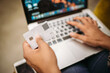 © Juri Pozzi/Westend61 - Close-up of woman using laptop and credit card
