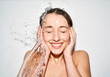 © philipp nemenz/Westend61 - Portrait of laughing young woman with splashing water