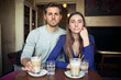 © philipp@nemenz.de/Westend61 - Portrait of young couple in a cafe with milk froth on lips