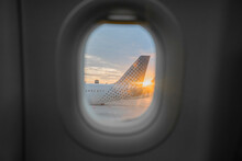 Airplane Tail Seen From Behind Window Of Adjacent Aircraft