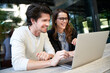 © philipp nemenz/Westend61 - Happy businessman and businesswoman with laptop meeting in the city